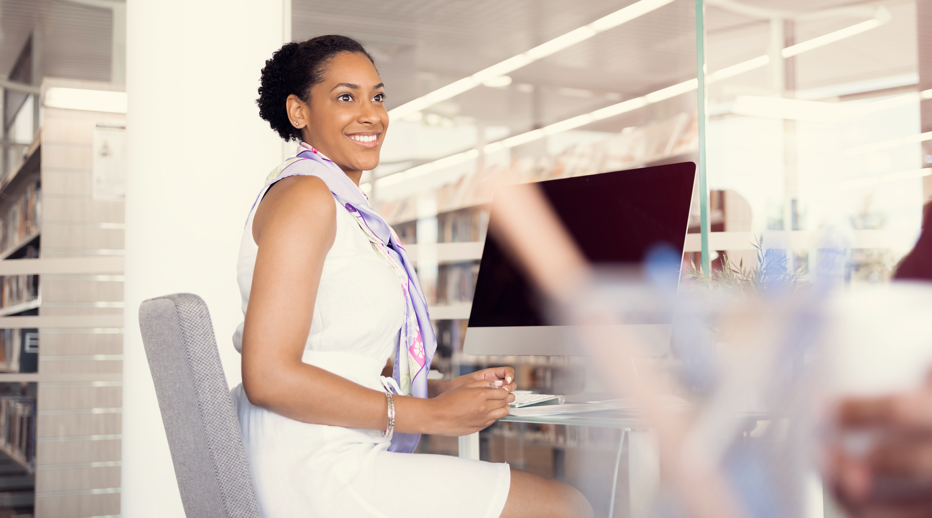 Women at desk with apple computer